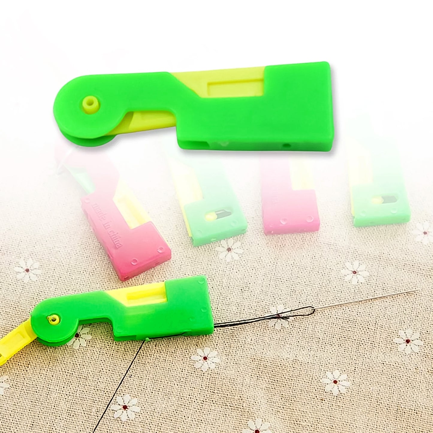 Wukusy automatic needle threading device in multicolour for home sewing, showing its compact design and colorful threading mechanism.