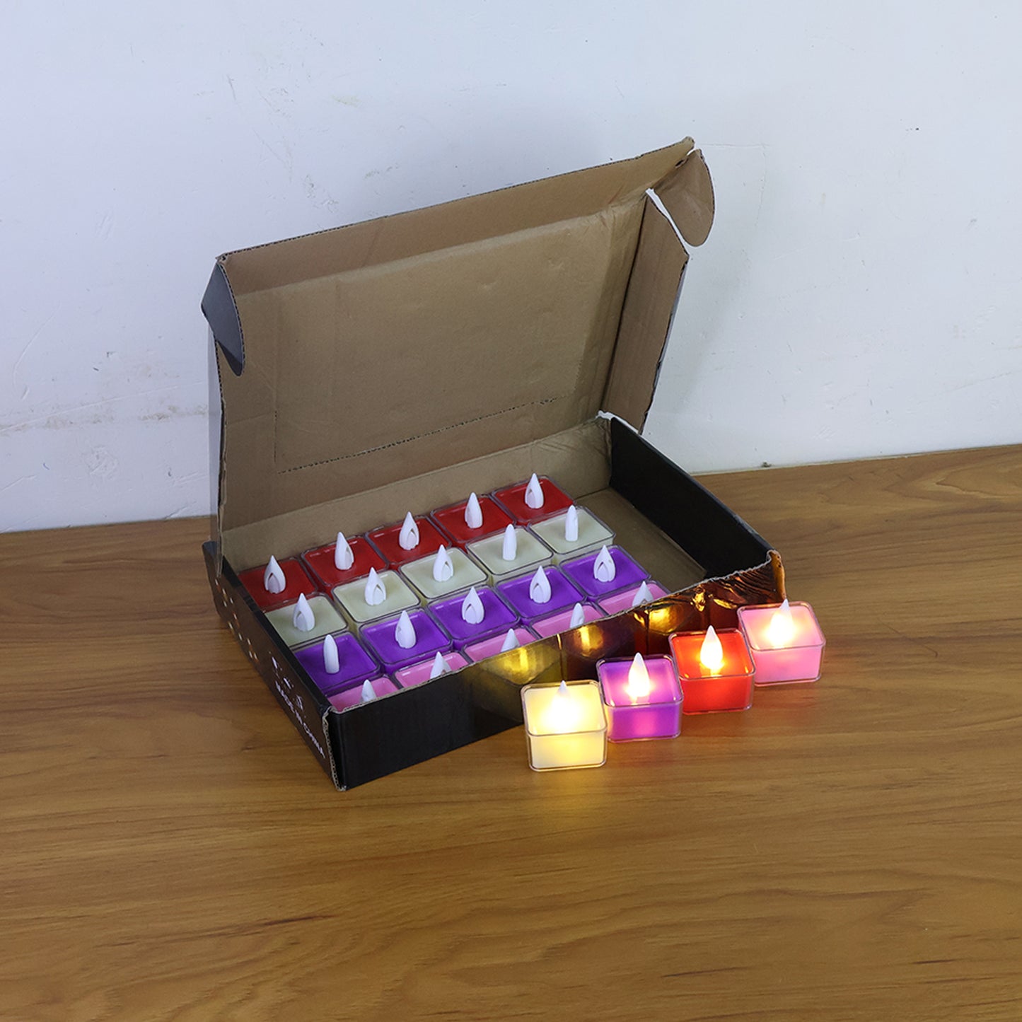 Set of 24 multi-color LED tealight candles for home decor by Wukusy, showing vibrant, glowing candles in a cozy setting.