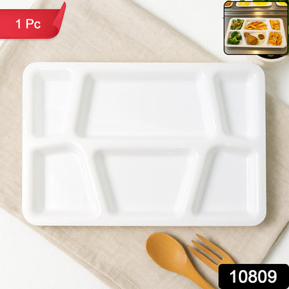 White plastic multi-compartment rectangular meal serving tray with several sections, designed for convenient food presentation.