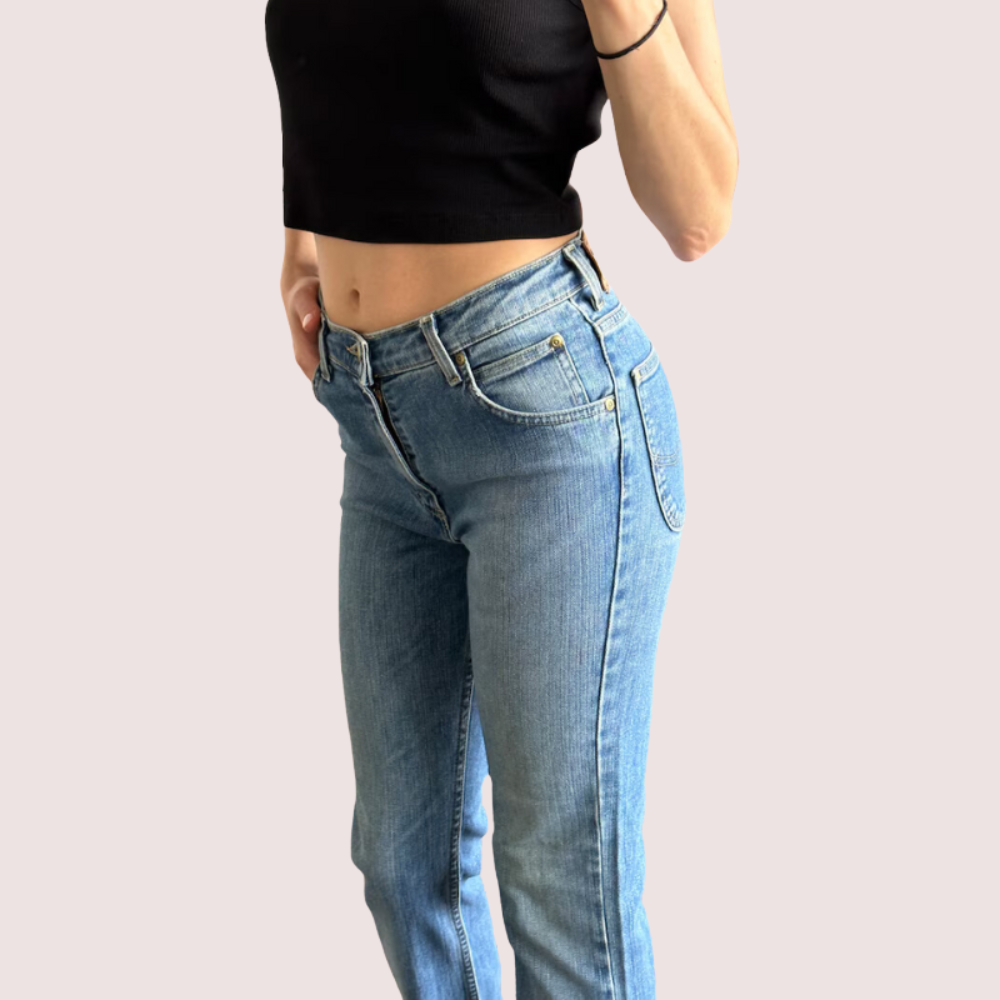 Light blue high waist denim jeans for women by Snazzyway, shown on a model with a casual pose and rolled-up cuffs.