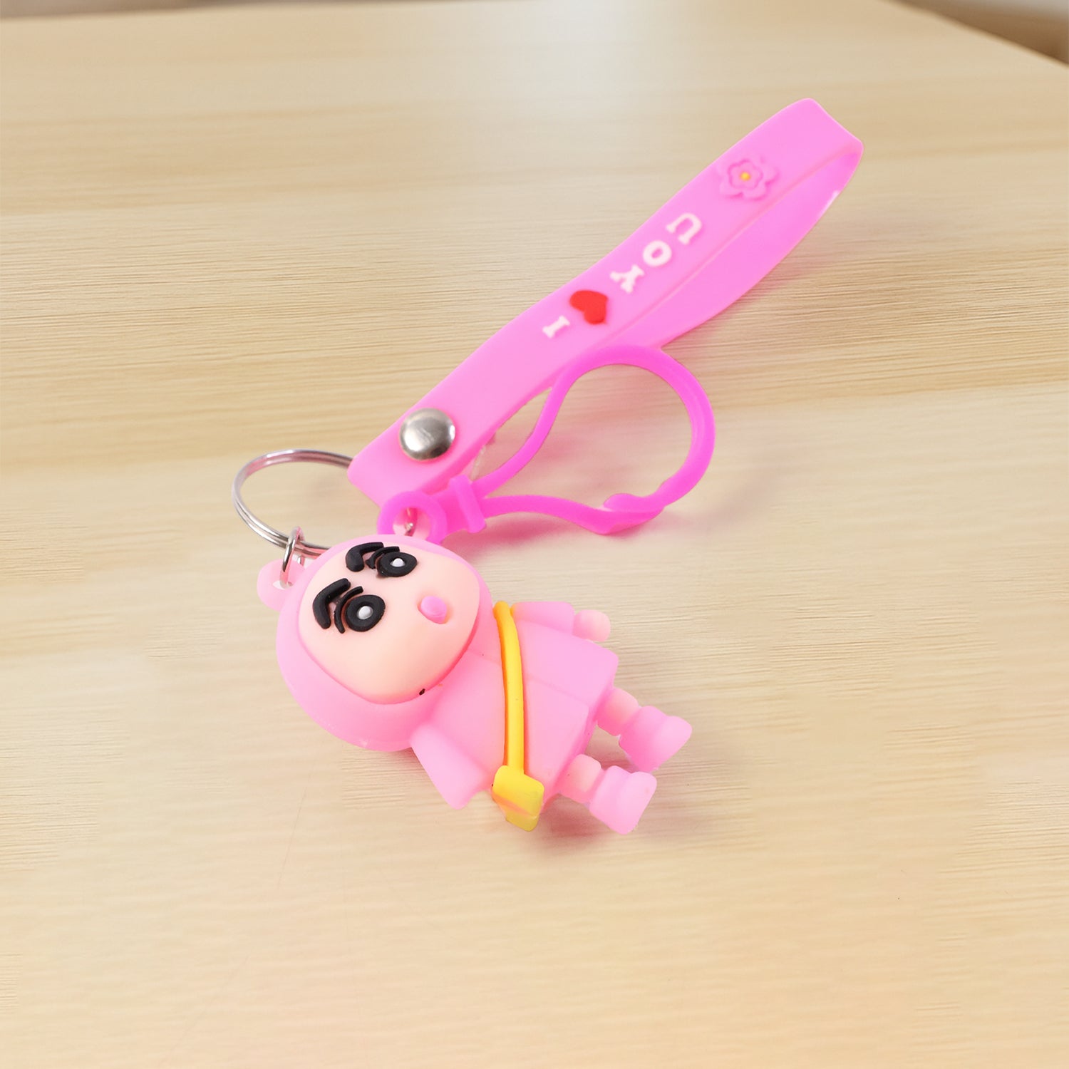 Cute cartoon doll figure keychain by Wukusy featuring a colorful, playful doll design attached to a metal keyring.