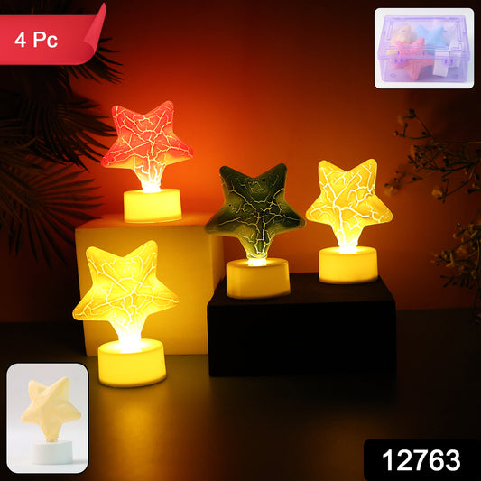 Four star-shaped decorative LED tealight candles by Wukusy for home decor, glowing softly on a table setting.