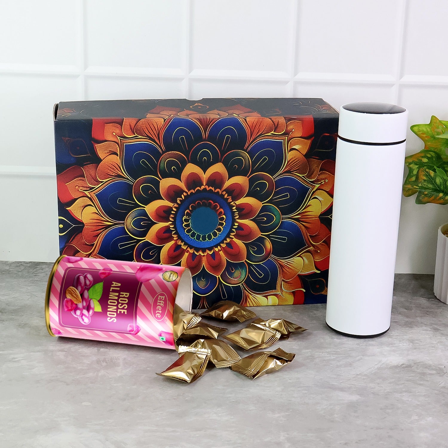 Wukusy Effete Rose Almonds Gift Hamper with golden packaging and a bottle, featuring two elegant home and kitchen gift sets.