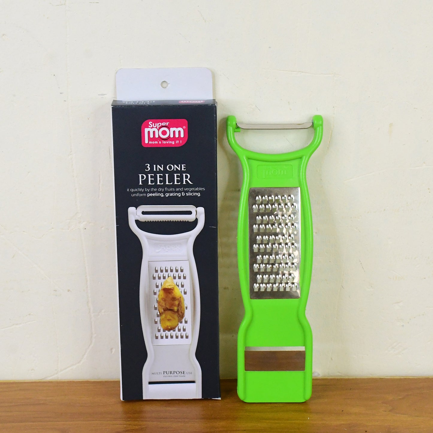 Wukusy Supermom 3-in-1 stainless steel vegetable and fruit peeler for kitchen use, featuring multi-functional design.