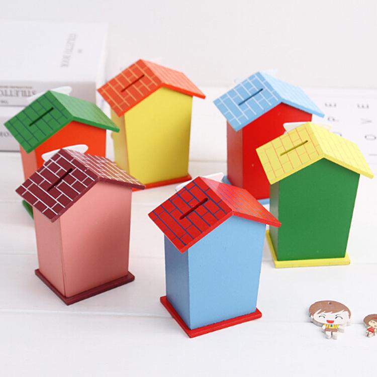 Cute cartoon house-shaped wooden piggy bank by Wukusy, with a charming design and coin slot for saving money.