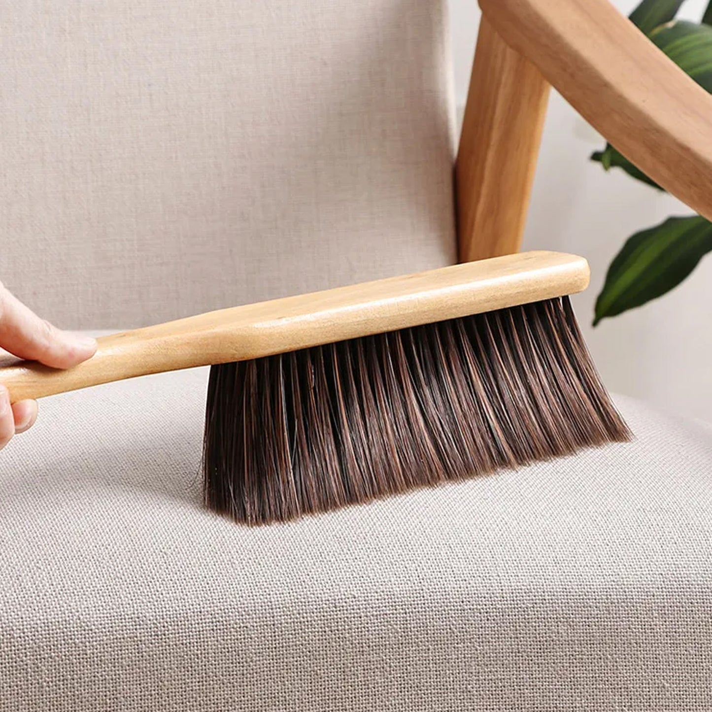 Wukusy dust cleaning brush with wooden handle and soft bristles for efficient dust removal from surfaces.