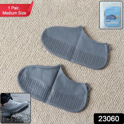 Pair of grey waterproof silicone shoe covers by Wukusy, medium size, protecting shoes from water and mud.