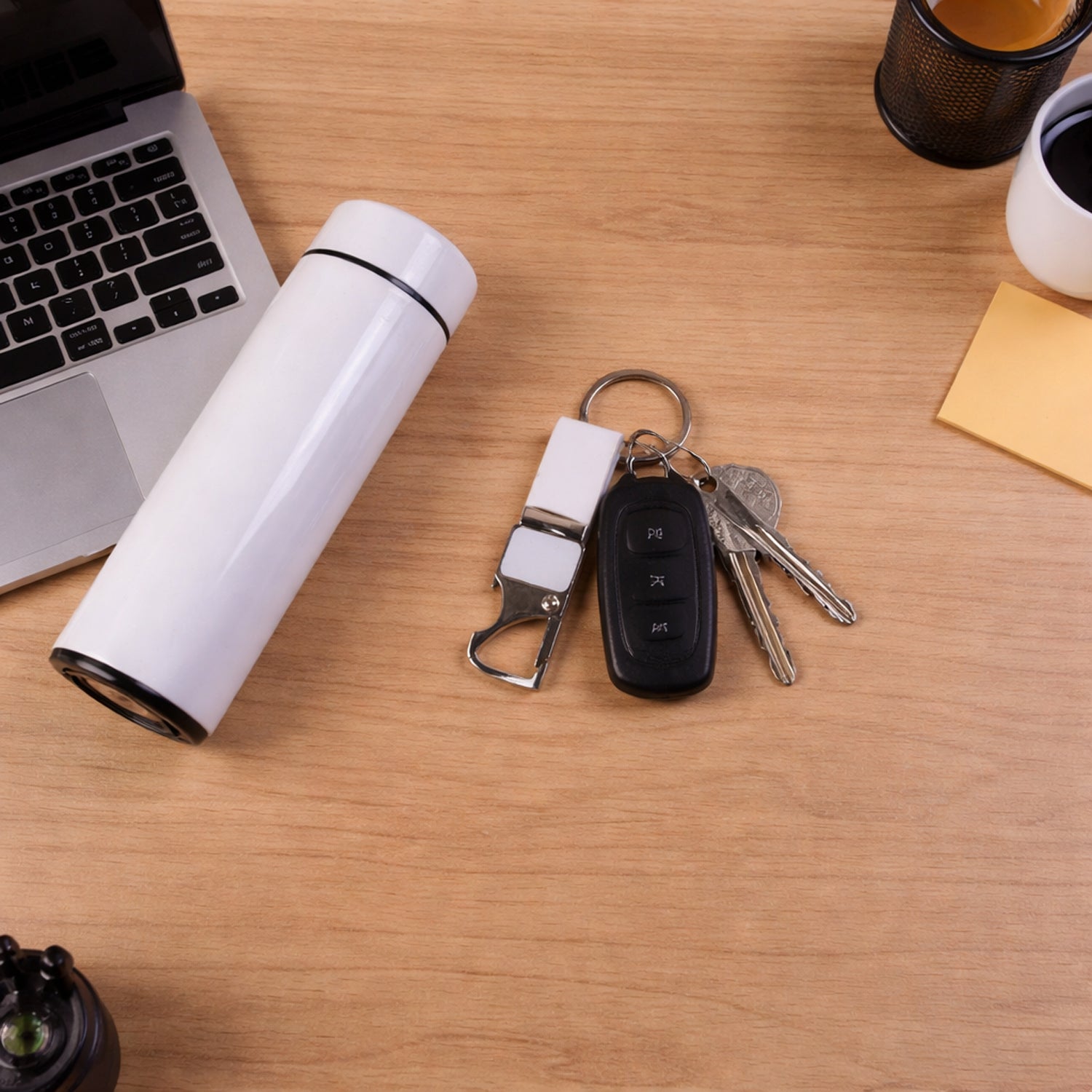 Wukusy Premium 4-in-1 corporate gift set including a pen, notebook, keychain, and USB drive arranged on a sleek display.