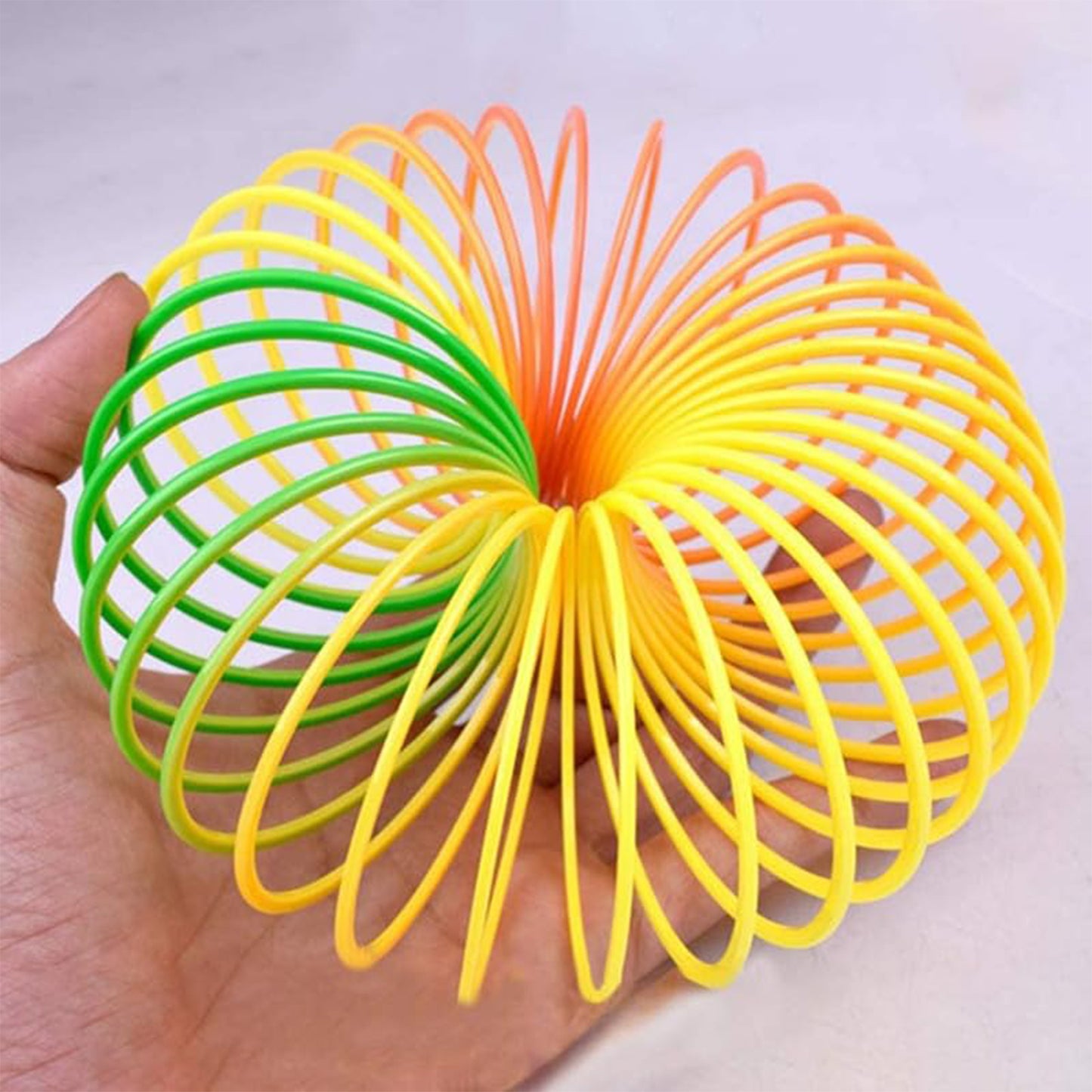 Wukusy Rainbow Spring toy, colorful flexible slinky for kids and adults, compact and portable for fun and entertainment.