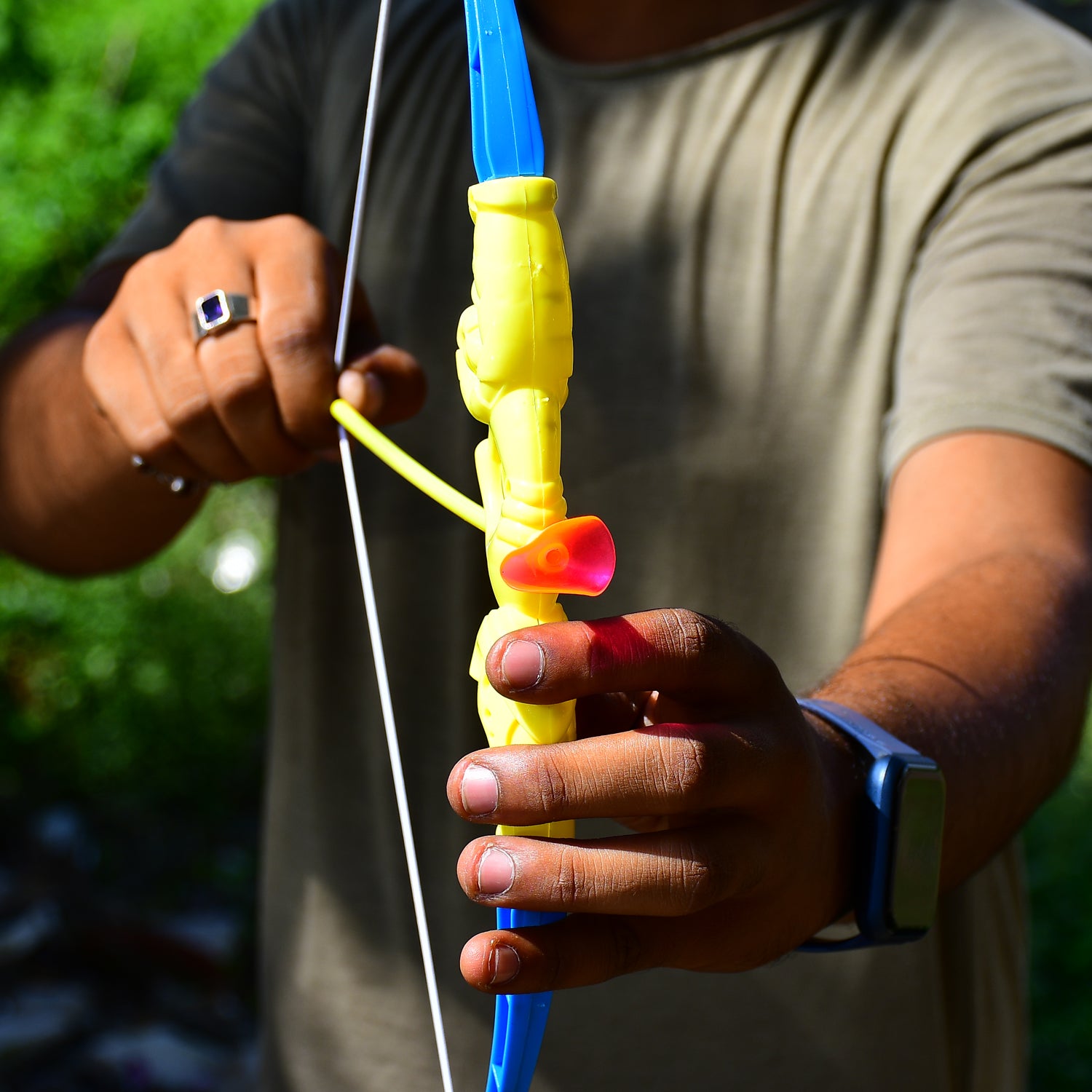 Wukusy plastic archery toy set with bow, 3 arrows, target board, and a small toy knife for children.