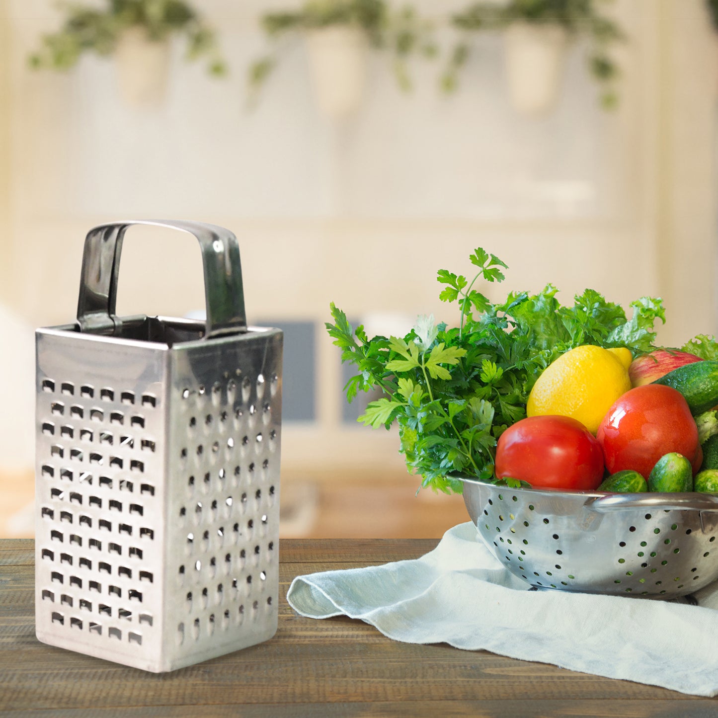 Wukusy Supermom Premium 4-in-1 stainless steel grater and slicer for kitchen prep, compact design with multiple blades for versatile use.