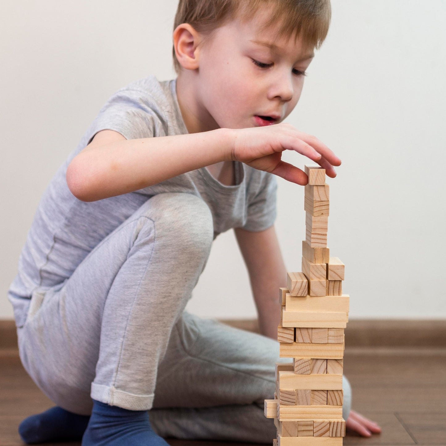 Wooden tumbling stacking toy with 54 blocks and 4 dice by Wukusy, perfect for building and imaginative play.