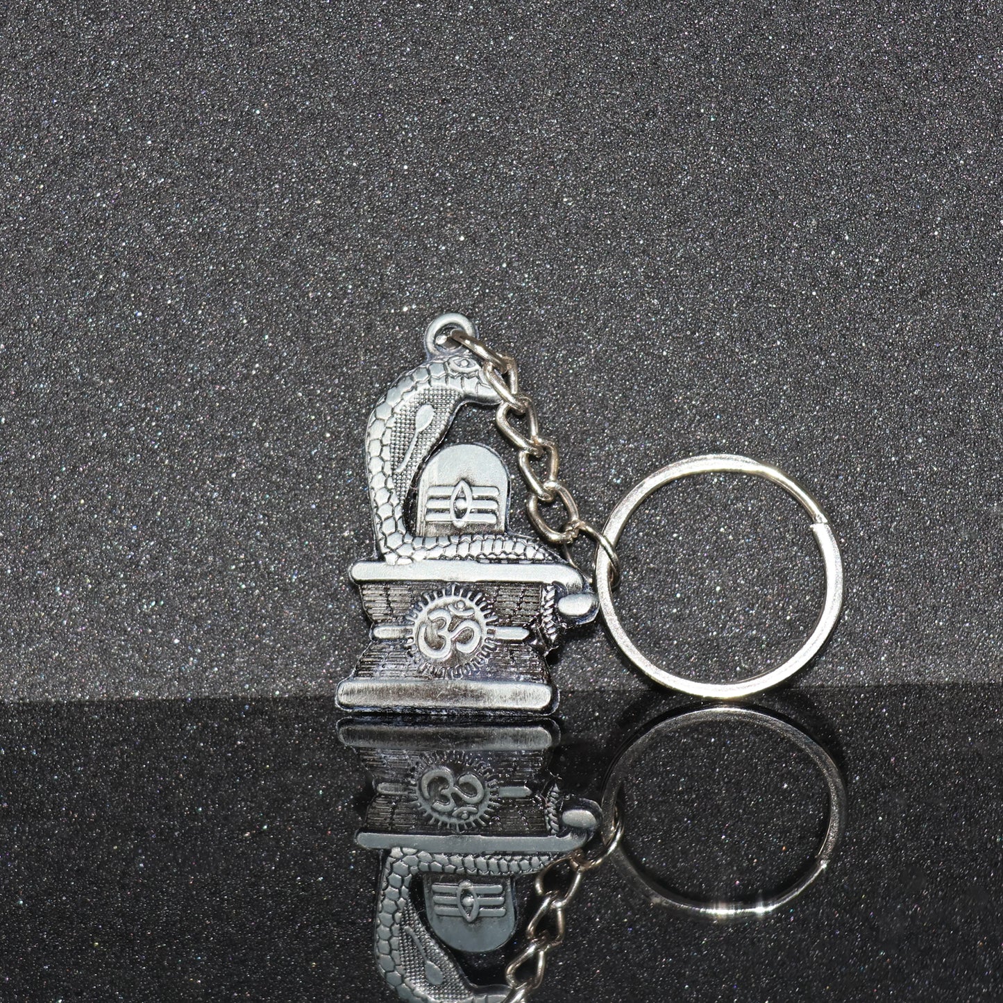Silver Shivling with snake design keychain by Wukusy, featuring intricate craftsmanship and detailed metallic finish.