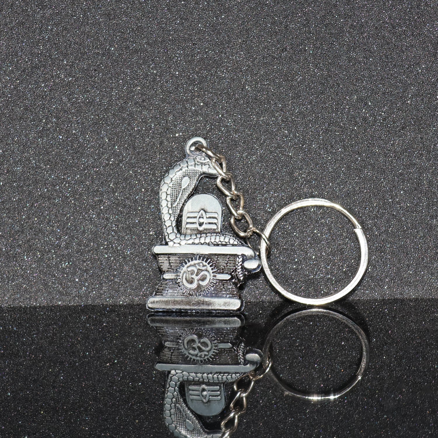 Silver Shivling with snake design keychain by Wukusy, featuring intricate craftsmanship and detailed metallic finish.