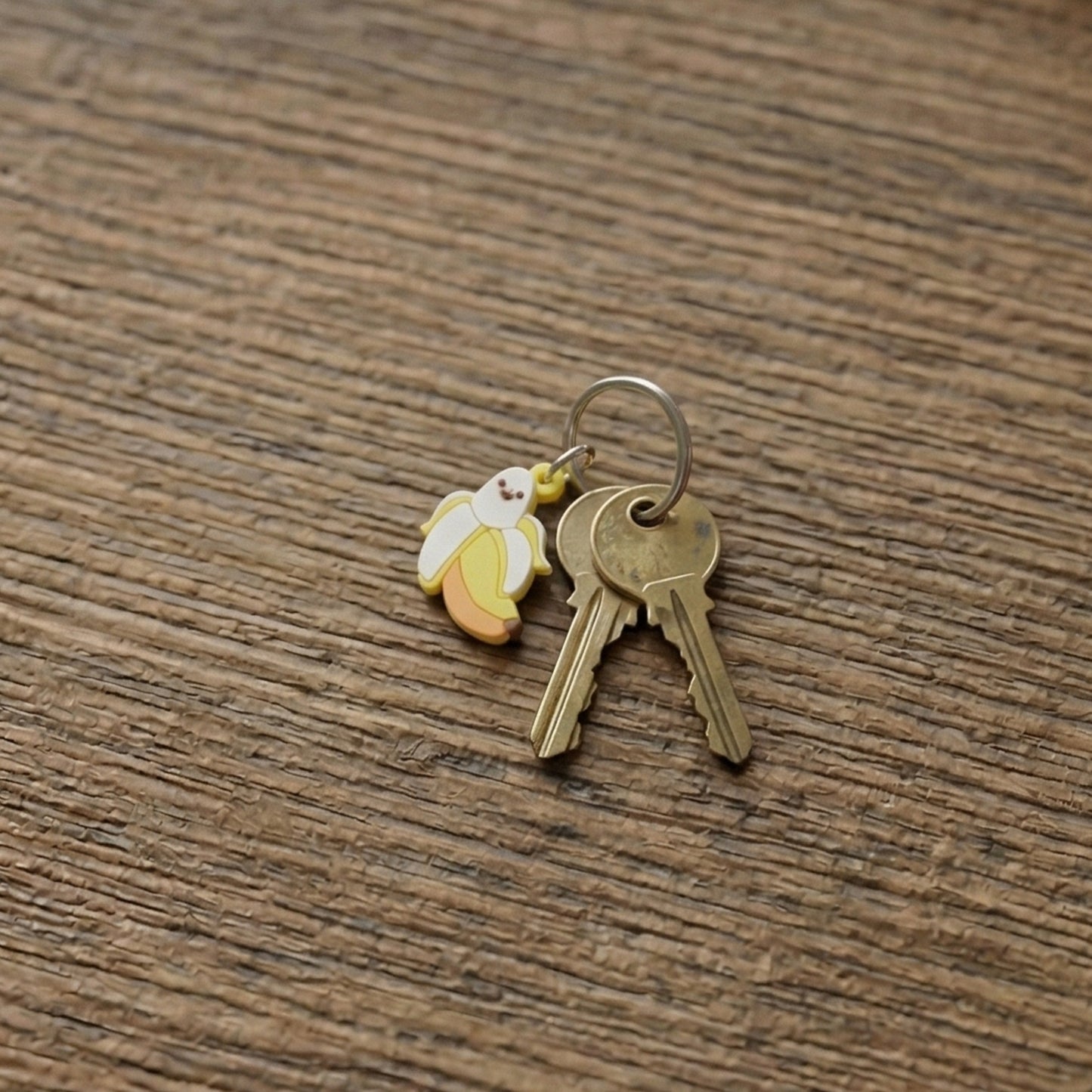 Set of 10 cute cartoon banana bag charm keychains from Wukusy, featuring colorful, playful banana designs on keychains.