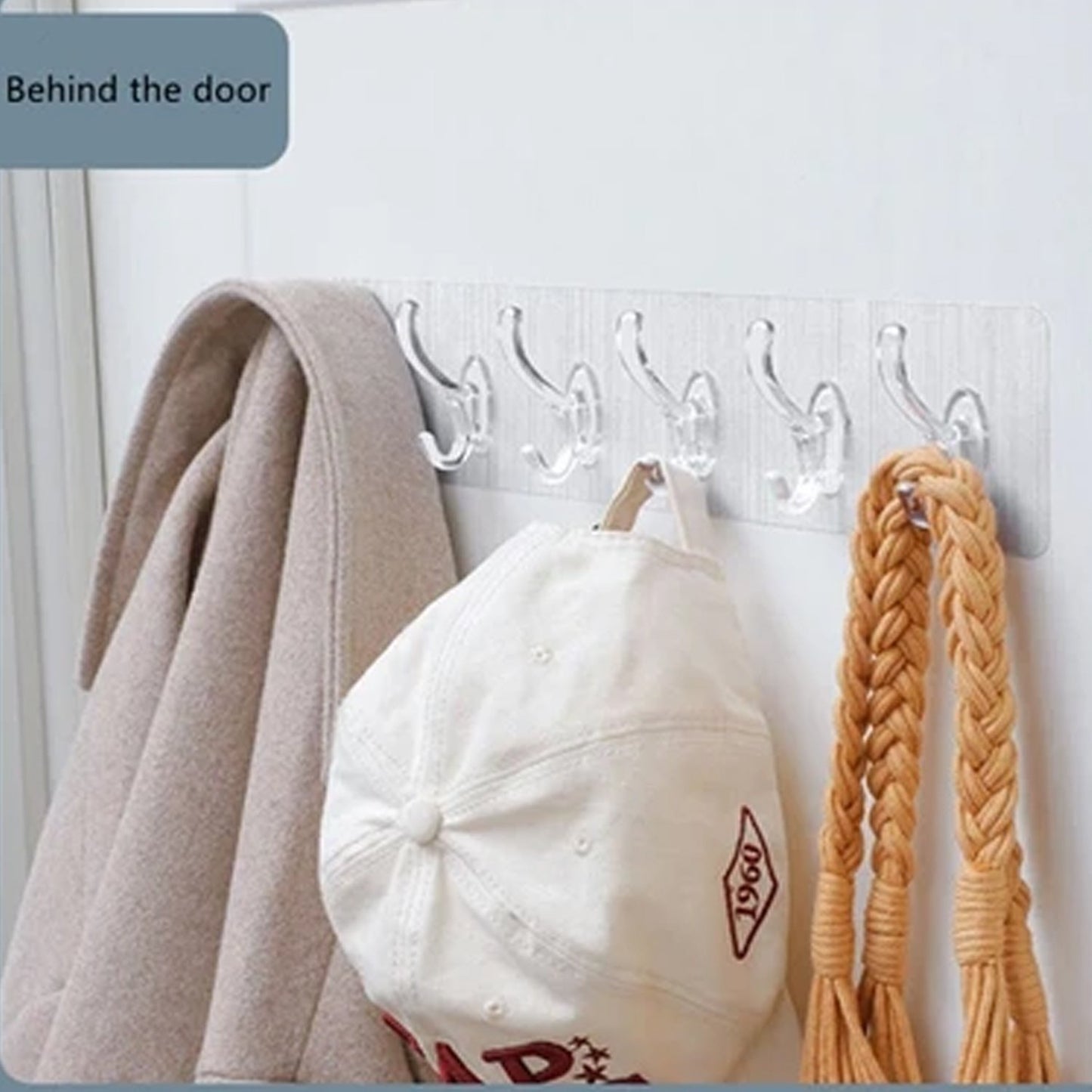 Wukusy 4654 heavy duty transparent adhesive wall hook attached to a wall, ideal for home improvement and hanging lightweight items.