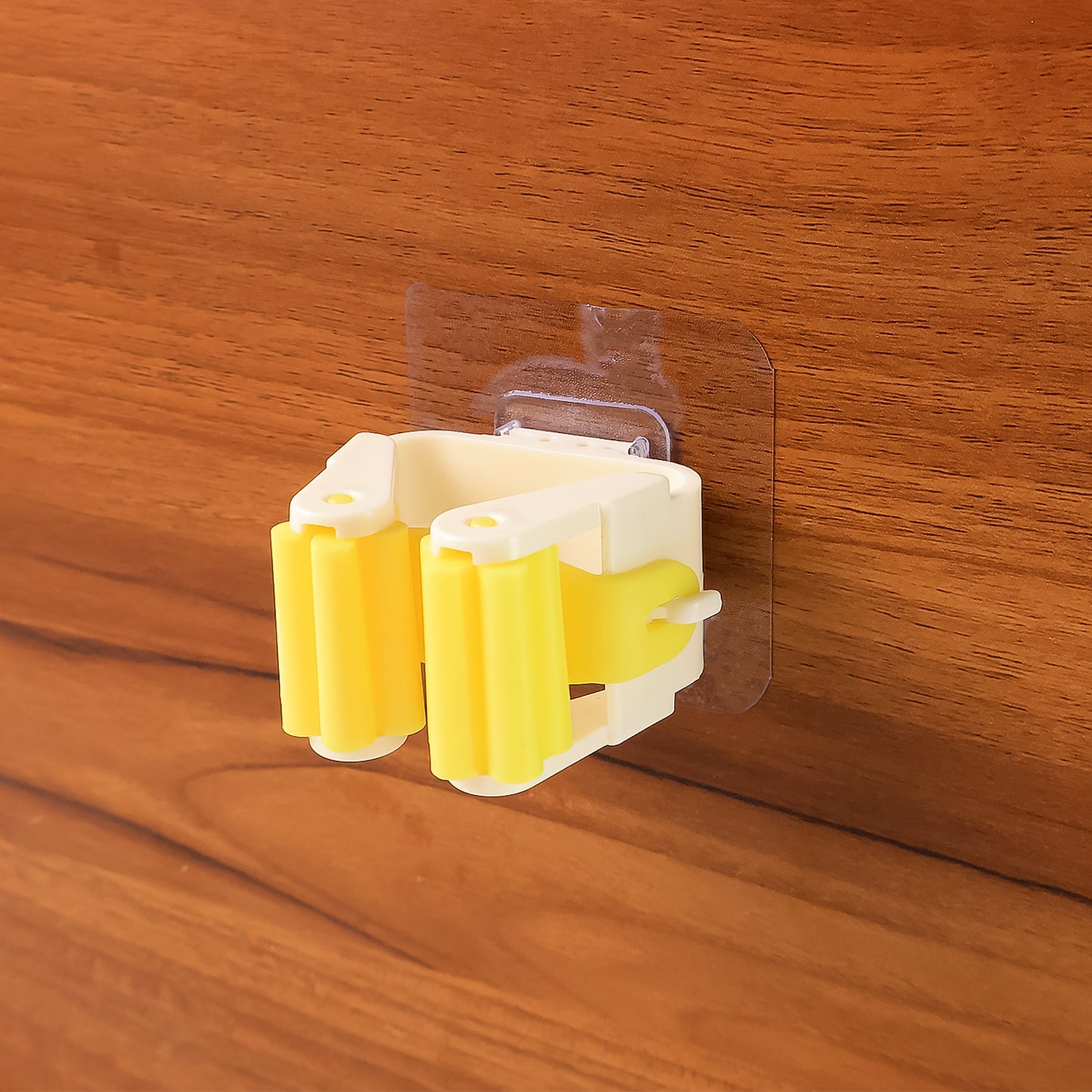 Wukusy Magic Sticker Series self-adhesive mop and broom holder attached to wall for home organization and cleaning tools.
