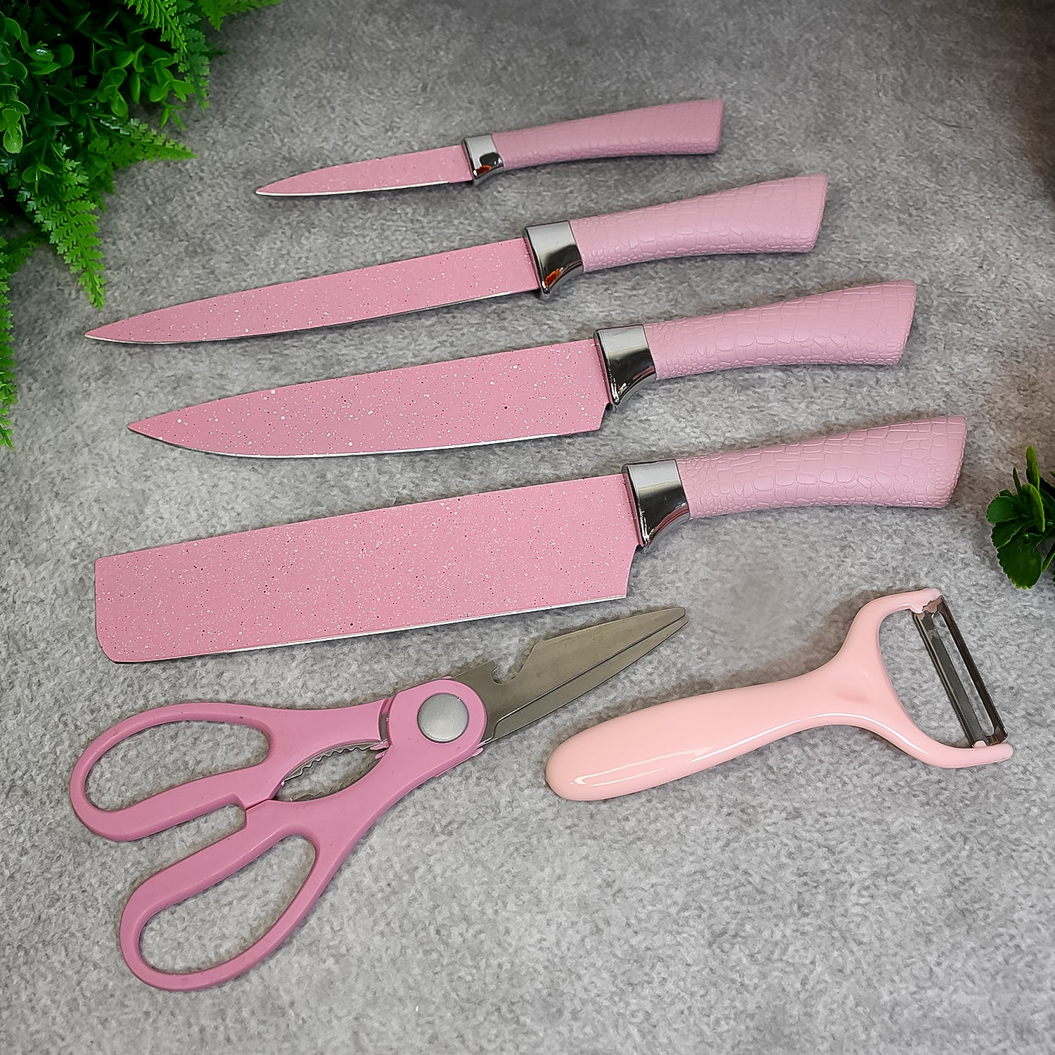 Wukusy stainless steel non-stick ceramic coating 6-piece chef knife set with scissors and peeler on a kitchen counter.