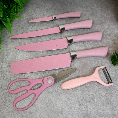 Wukusy stainless steel non-stick ceramic coating 6-piece chef knife set with scissors and peeler on a kitchen counter.