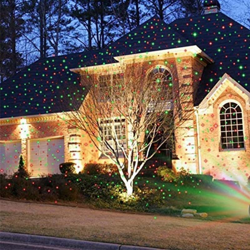 Wukusy 7350 Star Fairy Motion Laser Lights projector displaying multicolored star patterns on garden lawn, for outdoor home decoration.