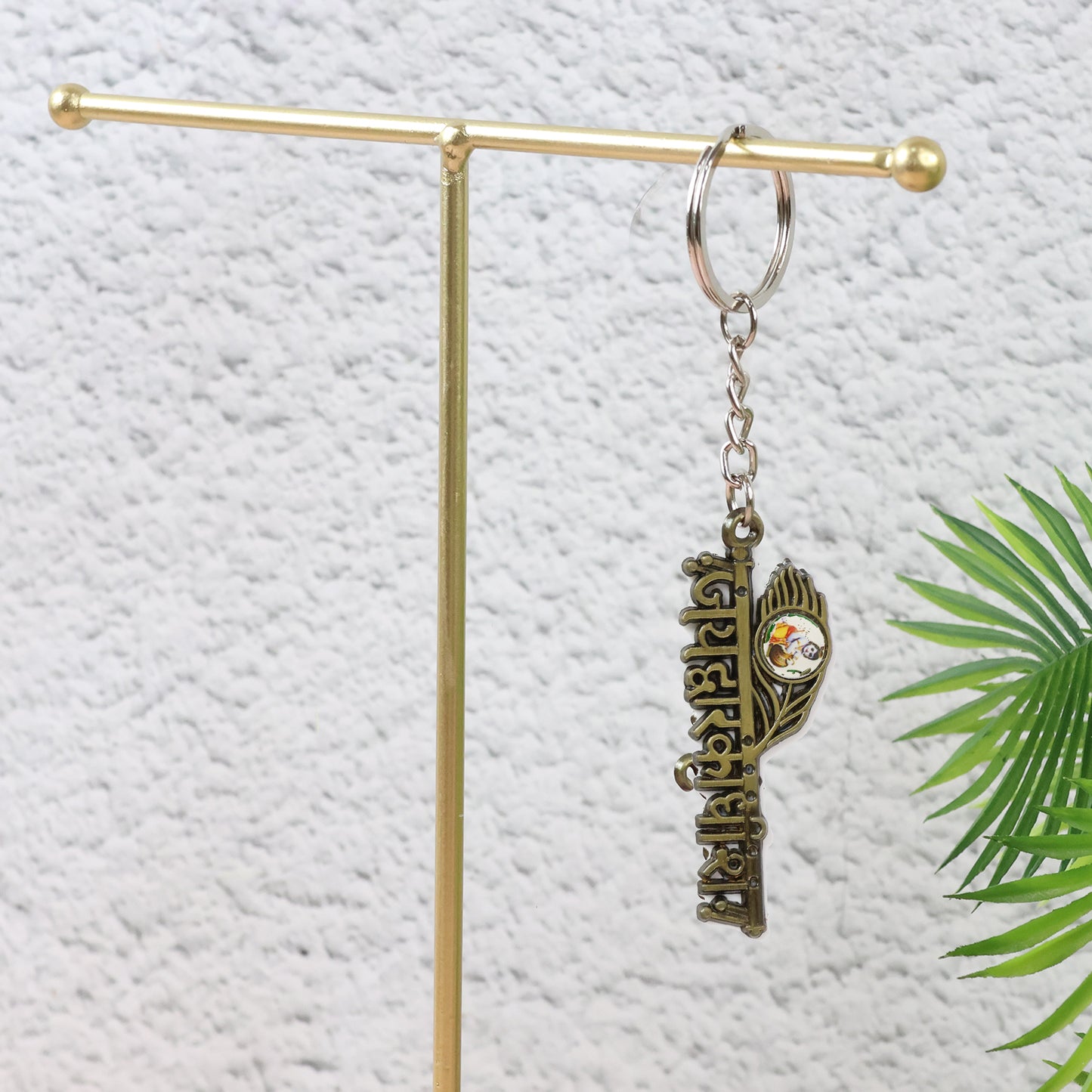 Metal keychain featuring Jai Dwarkadhish text by Wukusy, with intricate design and durable metal construction.