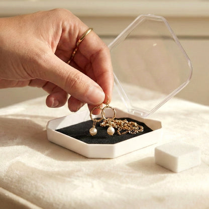 Wukusy jewelry display storage box with compartments for rings, earrings, and small jewelry items, shown with organized pieces inside.