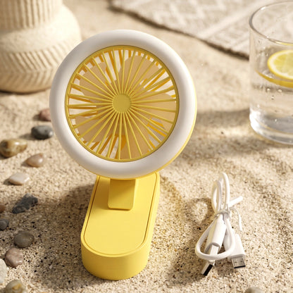 Wukusy portable rechargeable mini table fan with LED light, compact design, showing the fan with blades and illuminated LED panel.