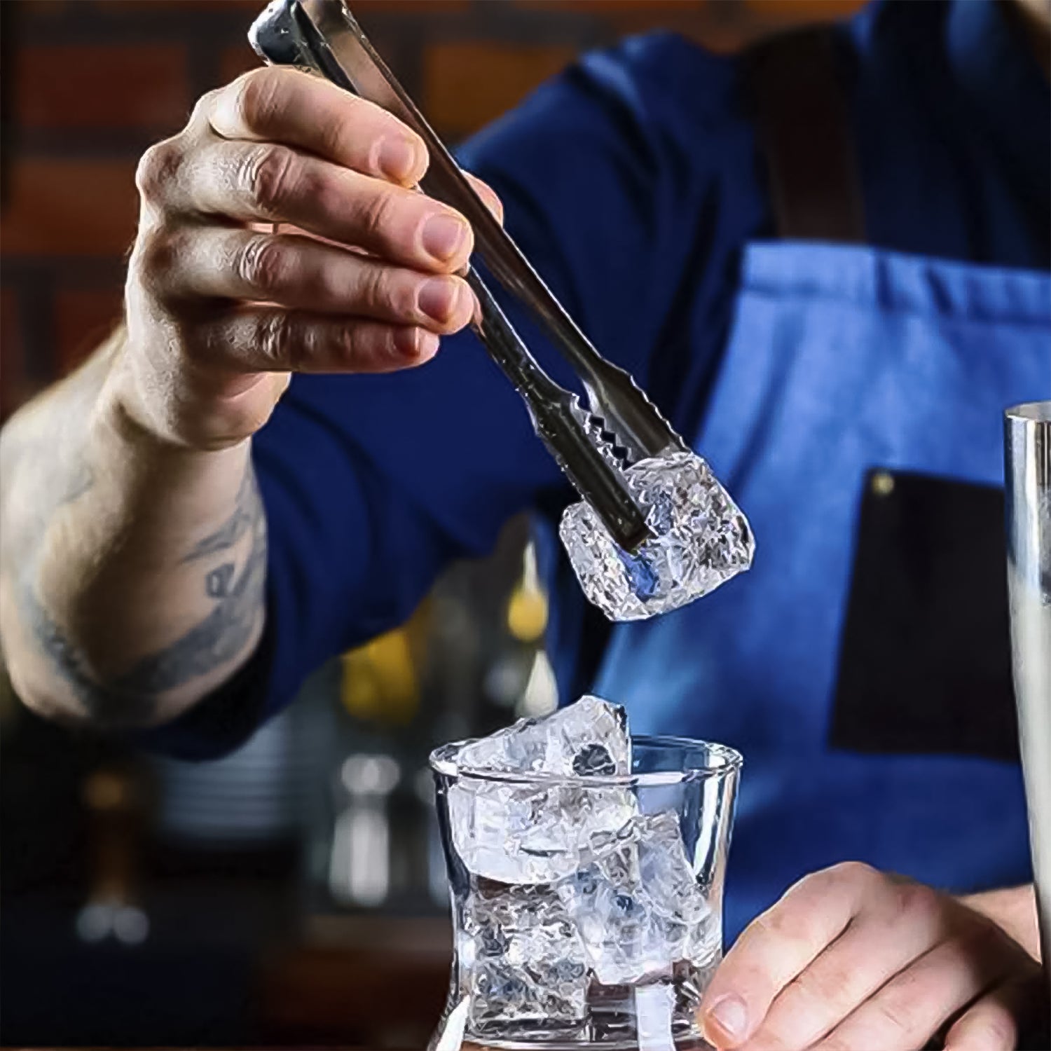 Wukusy stainless steel ice cube tongs, 13 cm, for lifting and serving sugar or ice cubes in a home kitchen setting.