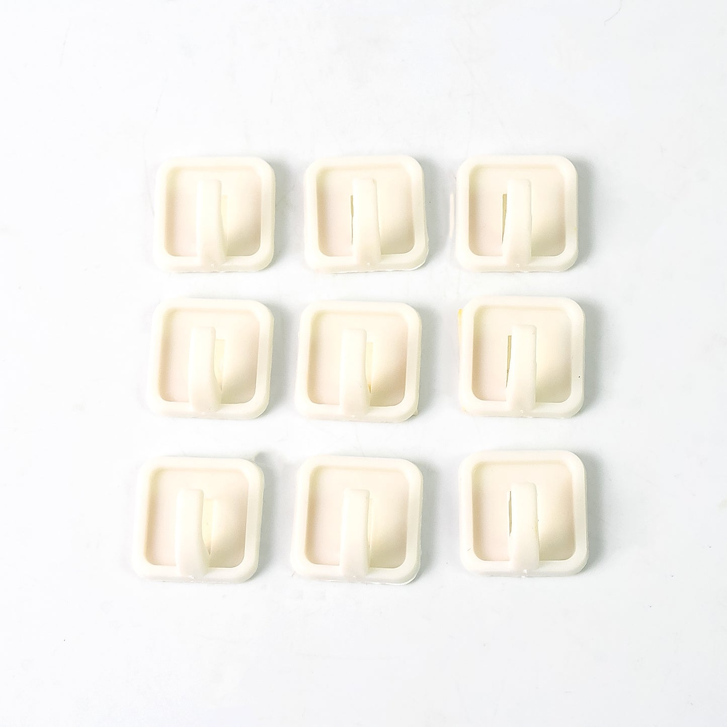 Set of 9 Wukusy adhesive hooks for wall hanging clothes, strong and easy to install for household organization.