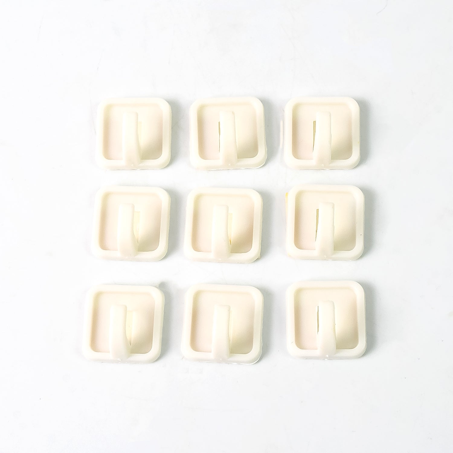 Set of 9 Wukusy adhesive hooks for wall hanging clothes, strong and easy to install for household organization.