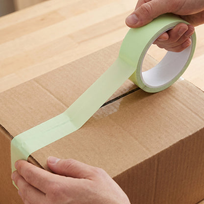 Wukusy strong adhesive glue tape roll for packaging boxes, 85x25 mm, shown unrolled on a surface.
