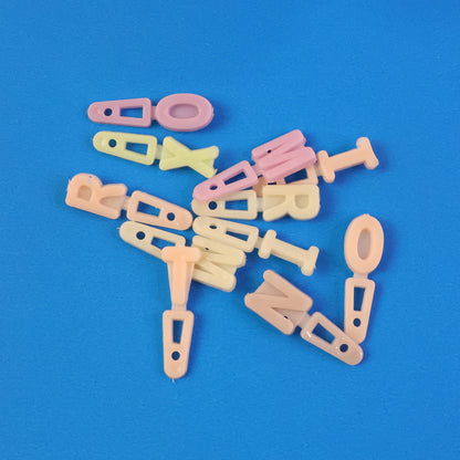 Set of colorful alphabet letter beads for craft decoration, featuring Wukusy brand beads on a white background.