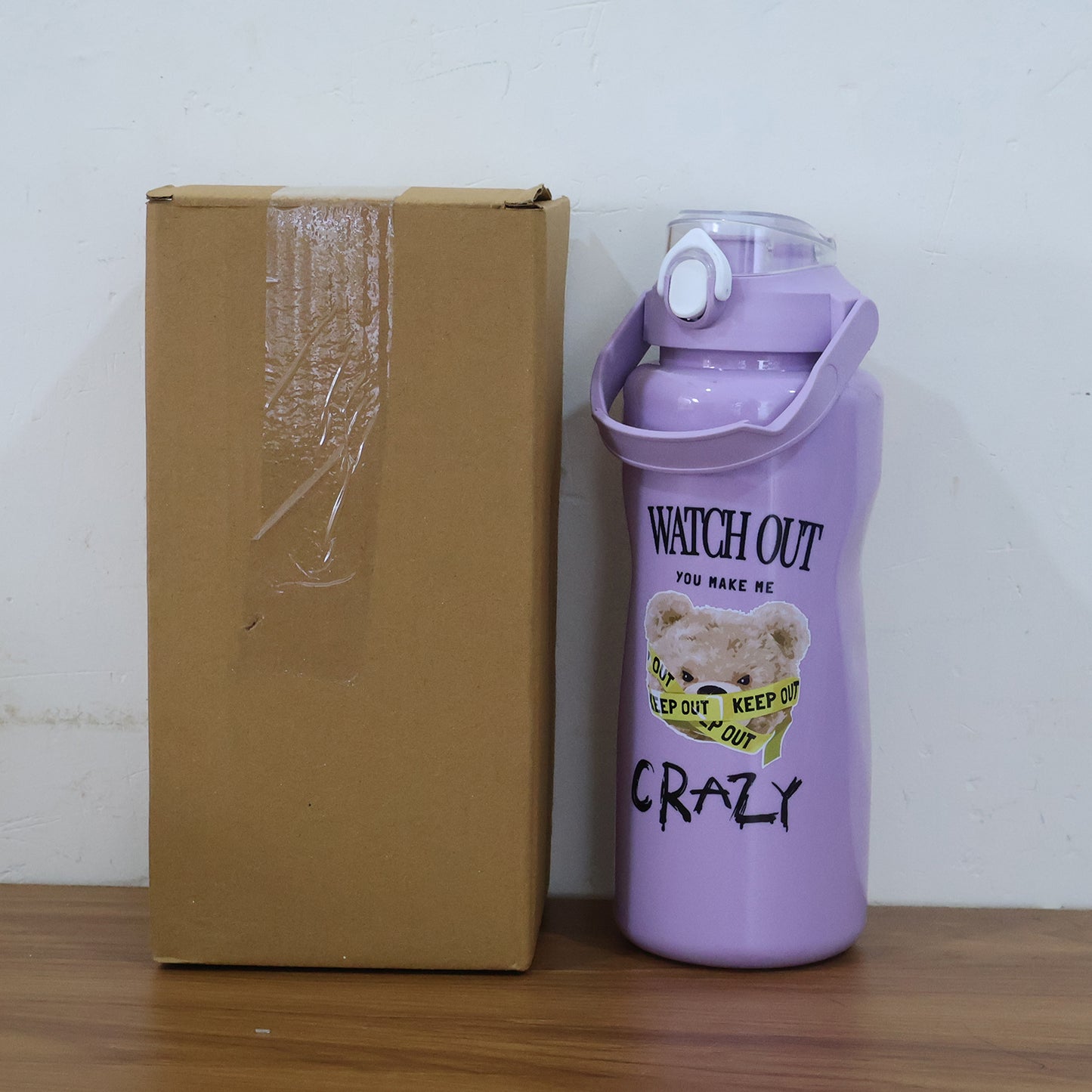 Set of Wukusy premium water bottles in 2000ml, 900ml, and 300ml sizes, shown in a home improvement setting.