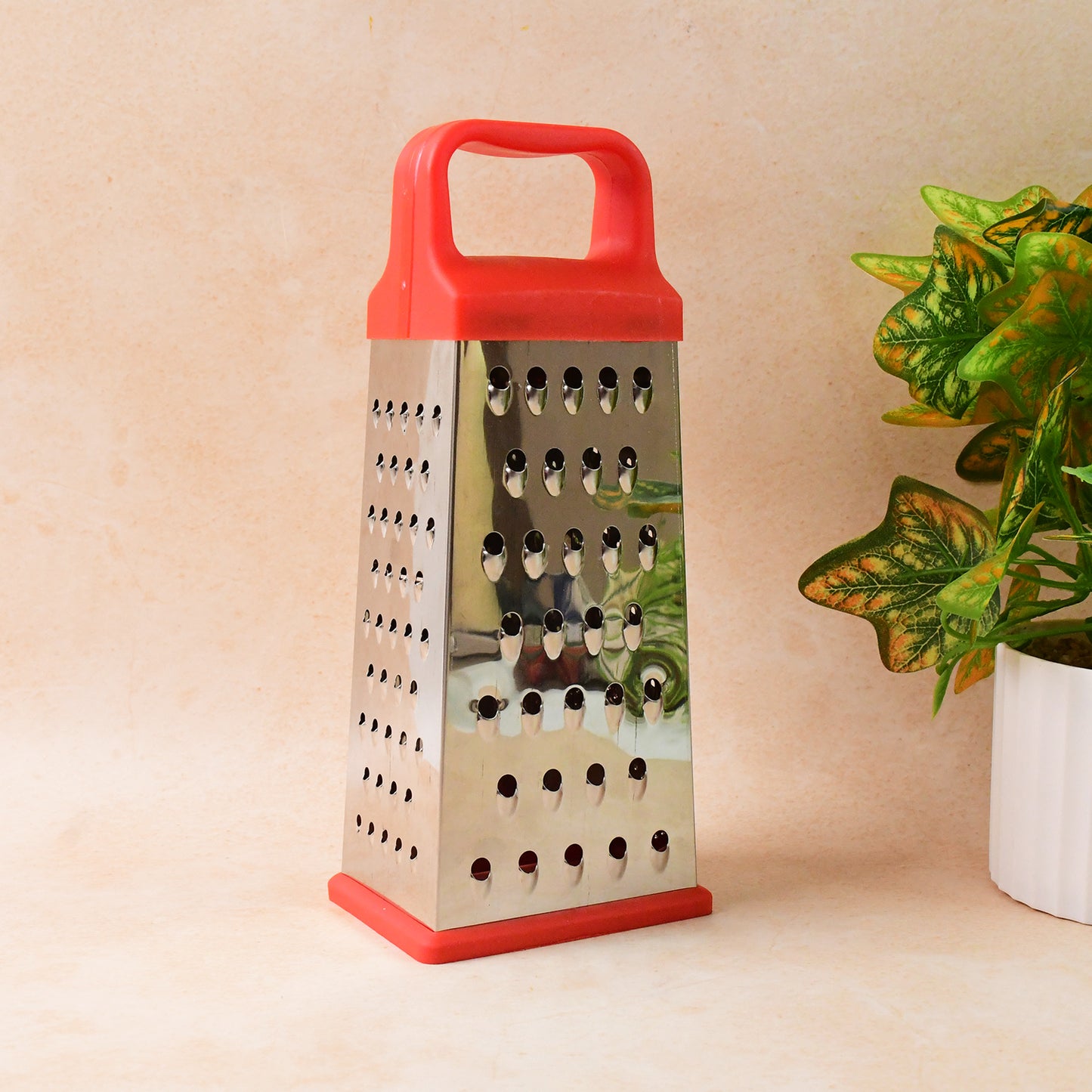 Wukusy Supermom 5-in-1 stainless steel grater and slicer for kitchen use, featuring multiple grating and slicing options.