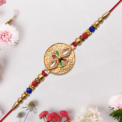 Antique finish Rakhi with intricate Meenakari and Kundan work, showcasing detailed craftsmanship in vibrant colors.