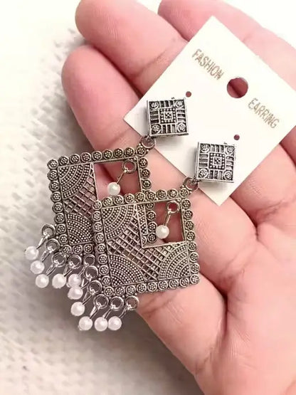 Set of four oxidized silver jhumki and hoop earrings for women and girls by Ekom, featuring traditional jewelry designs.