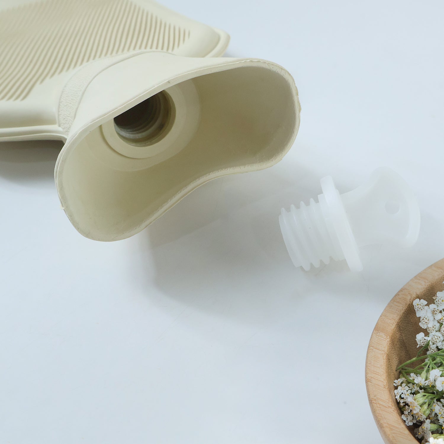 Reusable hot water bag for pain relief by Wukusy, showing a soft, flexible rubber bag with a fabric cover for warm compress therapy.