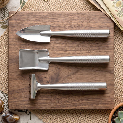 Wukusy stainless steel 3-in-1 garden hand tool set with spade, rake, and fork, arranged on a wooden surface.