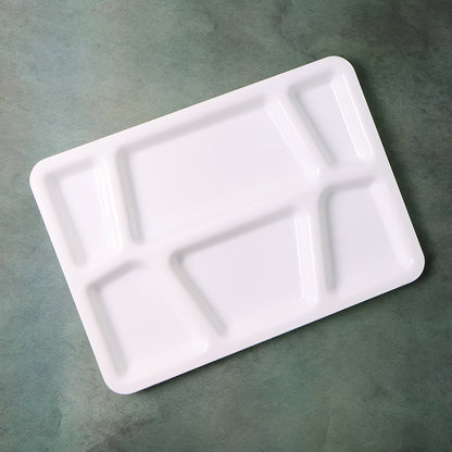 White plastic multi-compartment rectangular meal serving tray with divided sections for convenient food presentation.