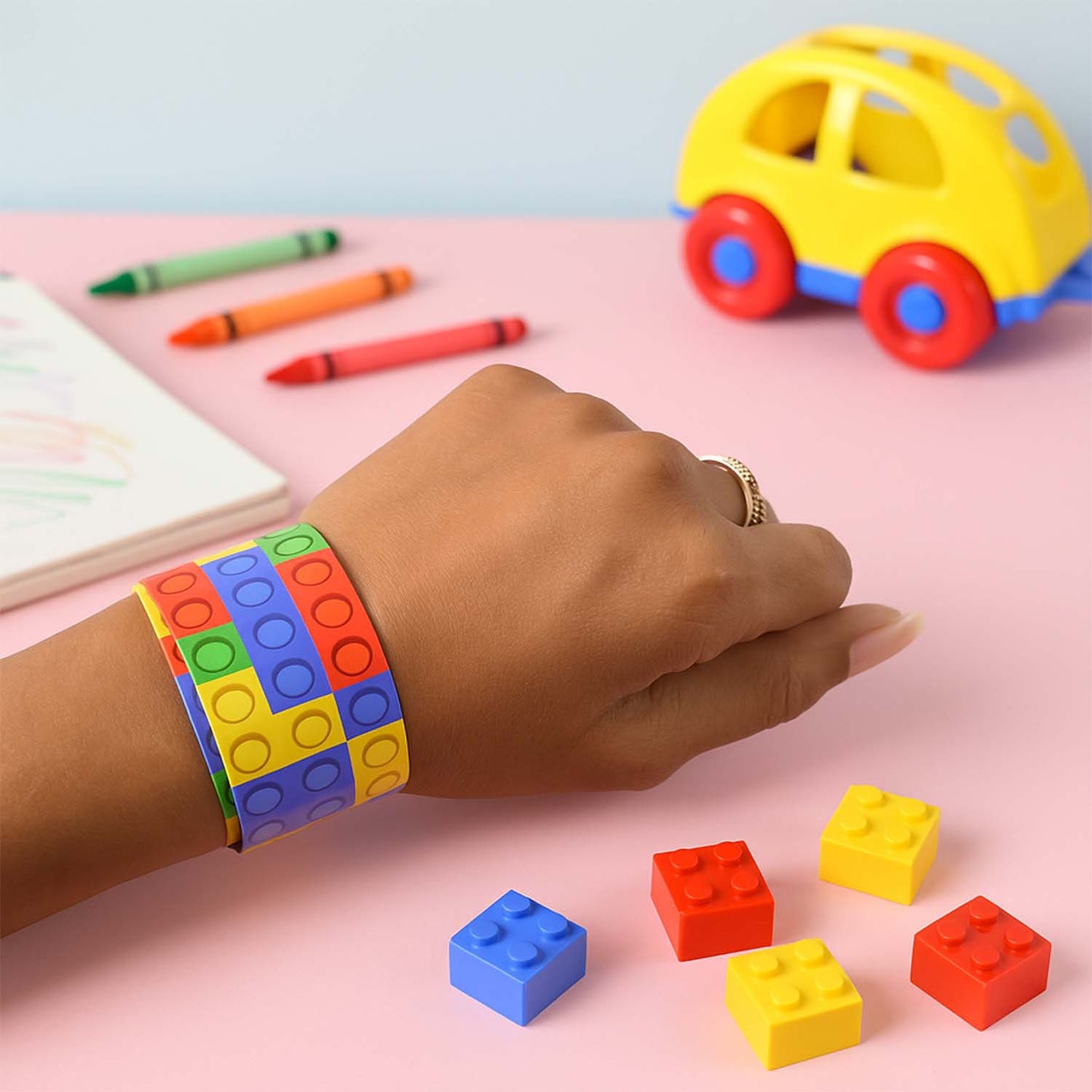 Colorful Snap Slap Bracelet Toy by Wukusy, featuring vibrant plastic segments that snap and slap onto wrists for fun and entertainment.