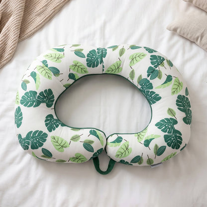 Green leaf print U-shaped travel neck pillow by Wukusy, soft head support for comfortable travel and neck relief.