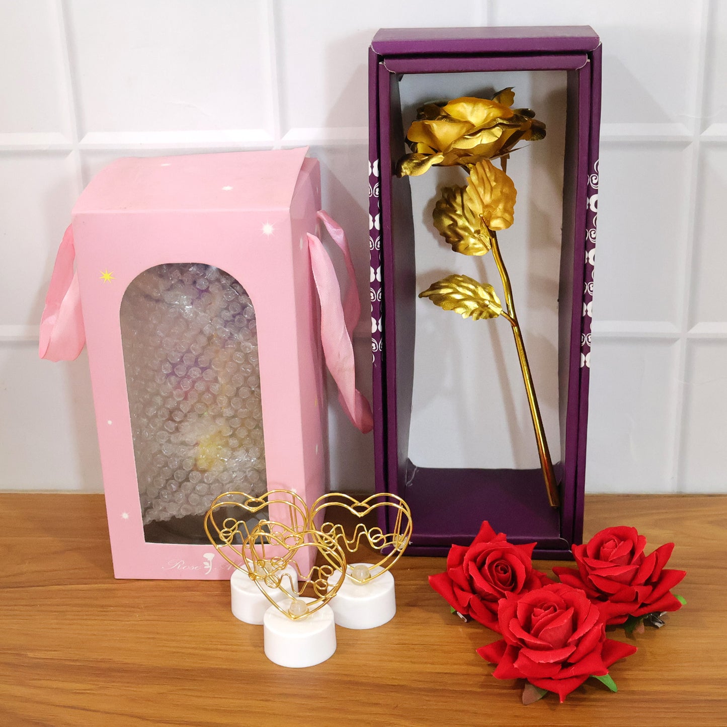 Romantic gift set from Wukusy featuring candles, chocolates, and love-themed accessories on a decorative tray.