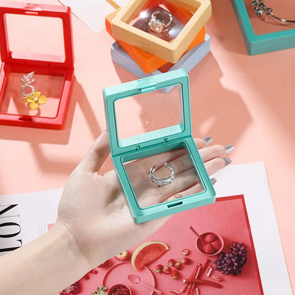 Transparent jewelry display box measuring 7x7 cm by Wukusy, showcasing a sleek, clear case for organizing and presenting jewelry.