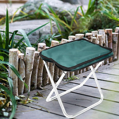 Wukusy folding camping stool, collapsible portable seat for outdoor camping and travel, compact little camping stool on a grassy background