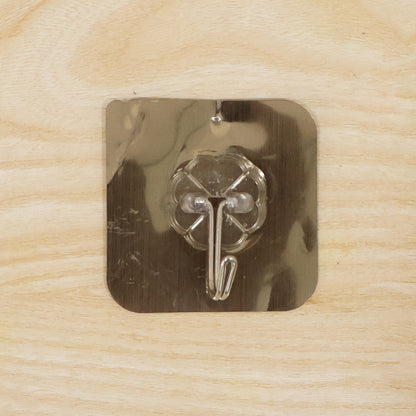 Self-adhesive plastic bathroom wall hook by Wukusy, showing a close-up of the hook attached to a bathroom wall for hanging items.