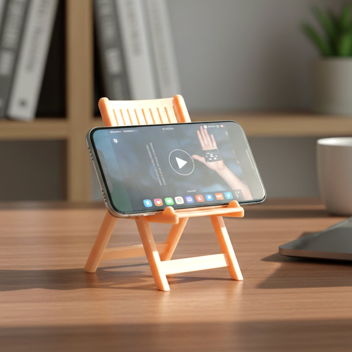 Peach-colored Wukusy mini chair-shaped mobile stand holder on a white background, showcasing its compact design and colorful appearance.