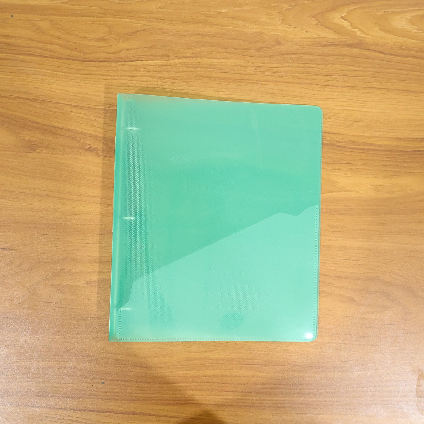 Wukusy A4 transparent ring binder file folder, 29.5x25.5 cm, showing clear view of the plastic cover and metal rings.
