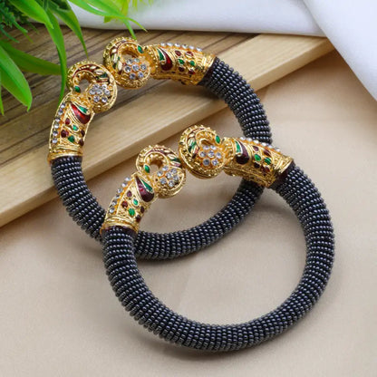 Traditional peacock design pearl bangles for women featuring intricate craftsmanship and elegant jewelry by Ekom.