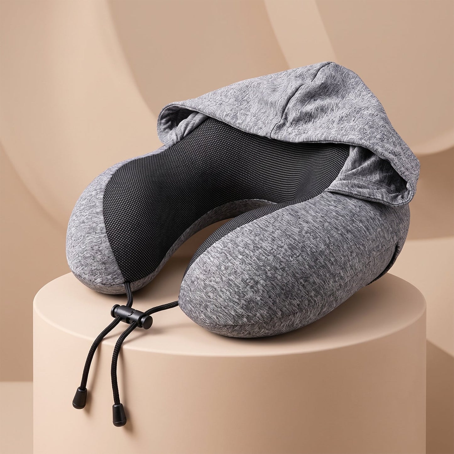 Grey U-shaped hooded travel neck pillow with drawstring hood by Wukusy, designed for comfort during travel.