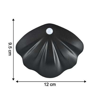 Shell-shaped Wukusy motion sensor night light for home decor, glowing softly with a shell design, ideal for cozy nighttime ambiance.